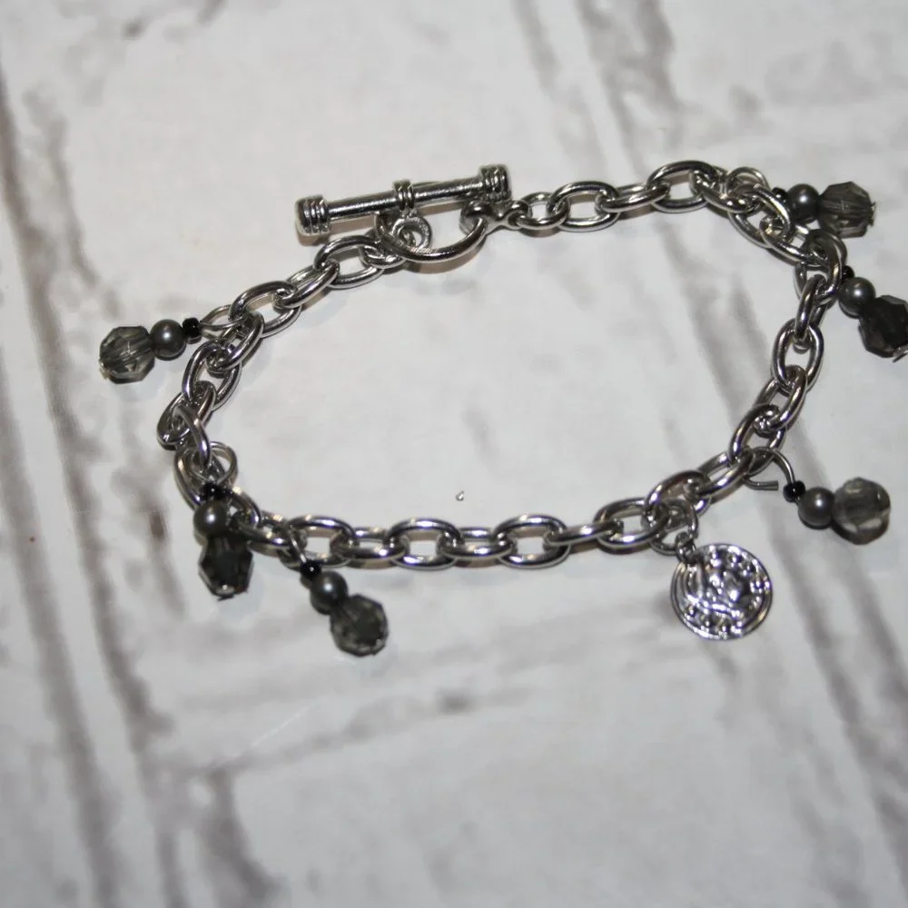Beautiful silver charm bracelet with coin charm 7.5